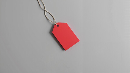 Red Gift Tag with String on Light Gray Background