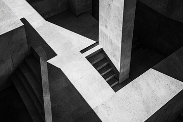 Fototapeta premium A top-down view of geometric architecture with sharp lines, casting bold shadows in the midday sun.