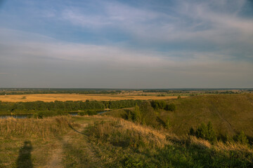 A large, open field with a river running through it