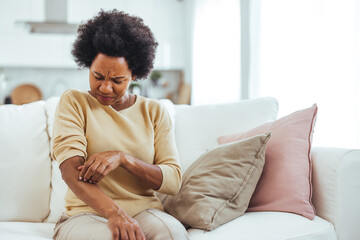 Woman Experiencing Skin Irritation While Sitting on Couch