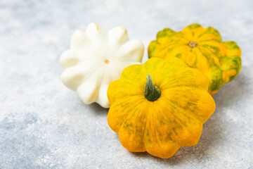Pattypan zucchini on a textured kitchen table. squash. Fresh organic pattypan squashes on...