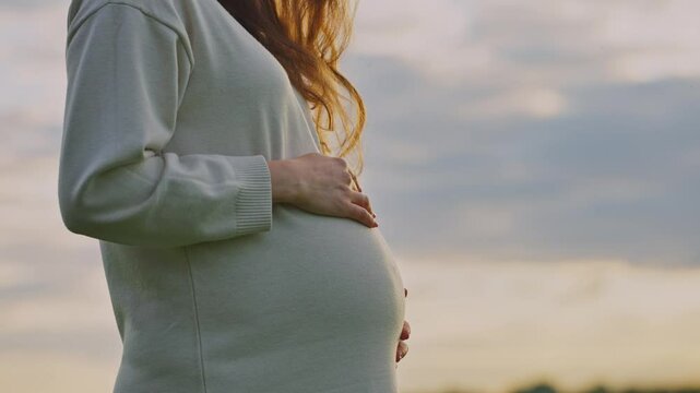 Expecting a baby during sunset at a serene outdoor location