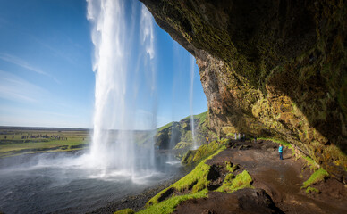 looking out form under Seljalandfoss waterfall, Iceland