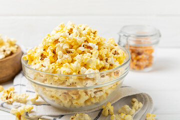 Salty popcorn on bright color background. Cinema and entertainment concept. Movie night with popcorn. Delicious appetizer, snack.Space for text, copy space. Banner