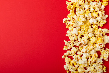 Salty popcorn on bright color background. Cinema and entertainment concept. Movie night with popcorn. Delicious appetizer, snack.Space for text, copy space. Banner