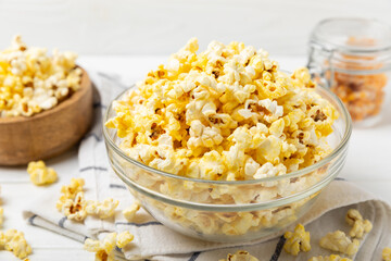 Salty popcorn on bright color background. Cinema and entertainment concept. Movie night with popcorn. Delicious appetizer, snack.Space for text, copy space. Banner