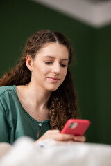 In the hospital, a resilient young lady uses her phone to share updates and receive well-wishes...