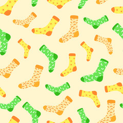 Vector pattern with colorful cute yellow, orange, green socks on a yellow background