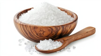 A wooden bowl filled with white sea salt and a wooden spoon with salt on it.