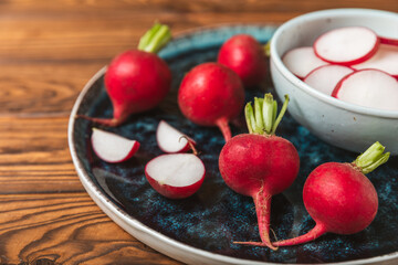Fresh radish on textured wooden background. Organic natural garden radish slices. clipping root crop. Vegetables. Vegan. Diet products. Healthy food. Place for text. Copy space.