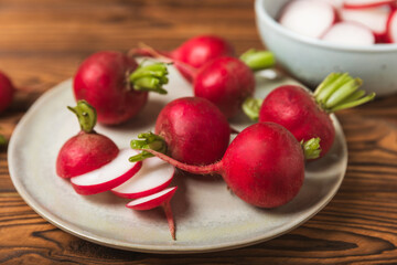 Fresh radish on textured wooden background. Organic natural garden radish slices. clipping root crop. Vegetables. Vegan. Diet products. Healthy food. Place for text. Copy space.