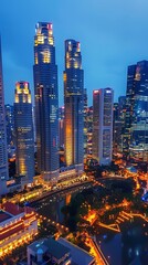 Obraz premium City skyline illuminated at dusk with towering skyscrapers and vibrant lights reflecting in the water near the waterfront in Singapore