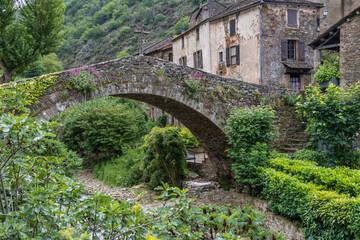 Fototapeta premium Brousse, France. 05-29-2024. Old paved stone bridge at Brousse le Chateau. Aveyron. Occitanie. France.