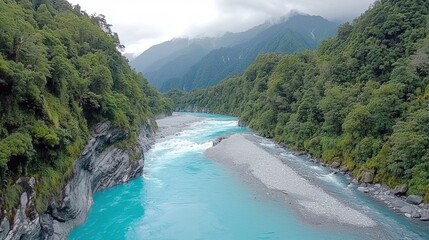 Majestic Turquoise River Flowing Through Rugged Alpine Landscape