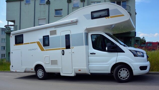 Kielce, Świętokrzyskie, Poland - 2022-06-18 - White car camper Ford Horon - side view.