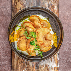 Ukrainian dish varenyky, vareniki, pierogi, pyrohy with sour cream sauce. top view