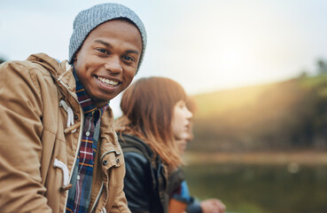 Winter, friends and portrait of man at lake with smile, fun bonding and outdoor adventure together....