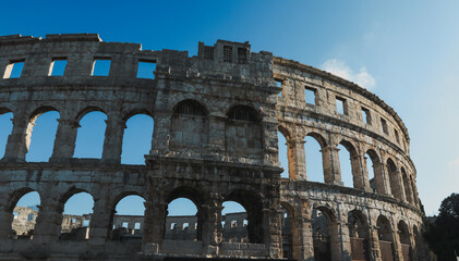 Exploring the ancient Roman amphitheater in Pula Croatia on a sunny day showcasing its impressive architecture and historical significance