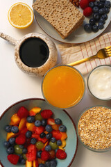 Assortment of various breakfast foods and drinks on the white table. Flat lay.