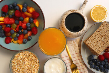 Assortment of various breakfast foods and drinks on the white table. Flat lay.