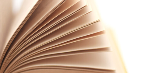 An open old book with pages are turned as wing closed up isolated on white