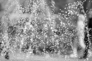 A blurry image of a fountain with water droplets falling from it