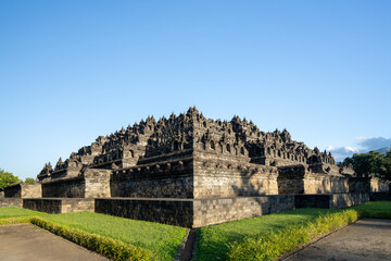 Borobudur, Mahayana Buddhist Temple in Indonesia - Mageland, Yogyakarta. Wide Angle of ancient stupa pyramid from north-west corner.