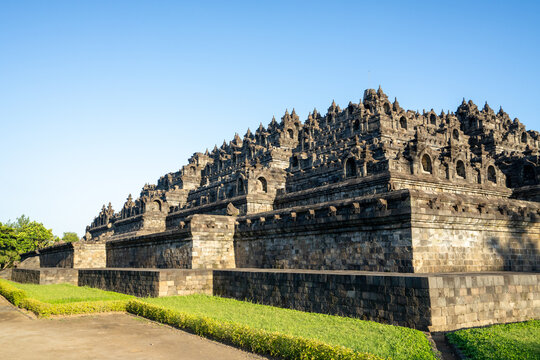 Borobudur, Mahayana Buddhist Temple in Indonesia - Mageland, Yogyakarta. Wide Angle of ancient stupa pyramid from north-west corner.