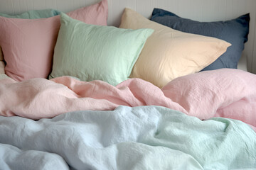 Bed with beautiful pink silk linens indoors