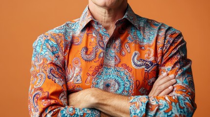 Obraz premium Close-up of a vibrant shirt with intricate pattern worn by middle aged serious person, posing by a solid background