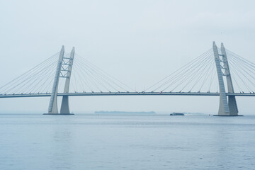 distant bridge over foggy bay on rainy day
