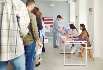 Fototapeta premium American voters at the polling station. Group of young people standing in line at the polling station during the election in the United States of America