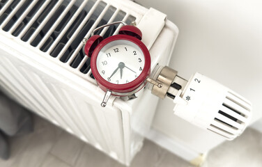 House heating inclusion concept. Battery clock to heat the room