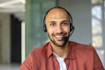 Happy customer service agent with headset providing assistance remotely. Confident professional...