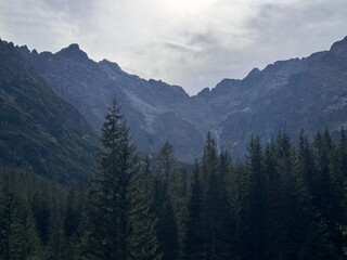 mountains in the morning, Picturesque fall landscape at Morskie Oko, with evergreen trees and stunning mountain backdrops. Great for themes of hiking, exploration, and natural beauty.