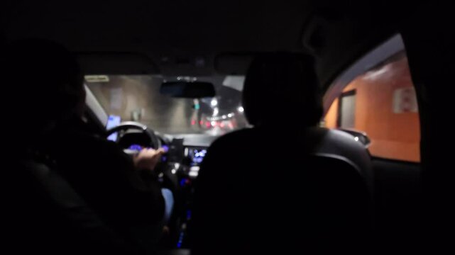 taxi passenger is driving through the night city