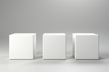 Three white cubes stand on a light gray background.