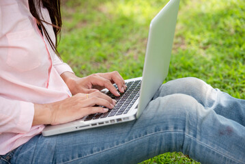 Happy smiling face businesswoman hand typing laptop drink black coffee cup green garden cafe. Woman Hands drinking hot coffee working from home. Business women enjoy sitting outddors lifestyle