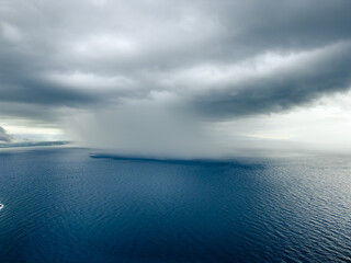 Cloudburst in the ocean near the coast. 