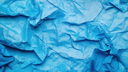 Obraz premium A textured background of crumpled blue paper perfect for artistic designs, displaying intricate folds and shadows that enhance creativity