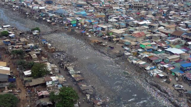 People live in slums immersed  immersed in toxic waste that poisons the land and river waters in Africa Africa Ghana  AGBOGBLOSHIE. high environmental pollution area , Climate change global warming 