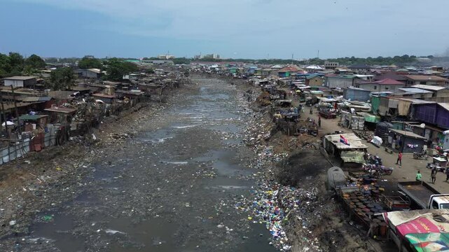 Ghana, Accra,   AGBOGBLOSHIE drone view Odaw River the largest landfill illegal dump in Africa for electronic and plastic waste from the Western world. mountain of toxic waste, environmental disaster 