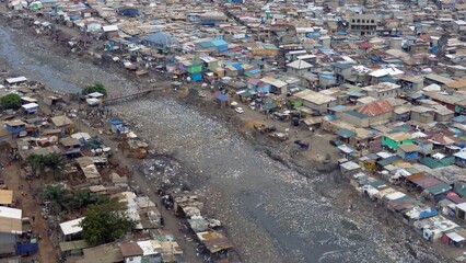 People live in slums immersed  immersed in toxic waste that poisons the land and river waters in...