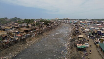 People live in slums immersed  immersed in toxic waste that poisons the land and river waters in Africa Africa Ghana  AGBOGBLOSHIE. high environmental pollution area , Climate change global warming 