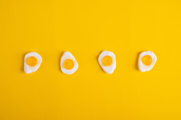 Egg jelly candy isolated on the yellow background