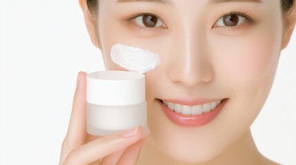 A smiling woman holds a skincare cream jar, promoting beauty and skincare routines with a fresh, healthy appearance.