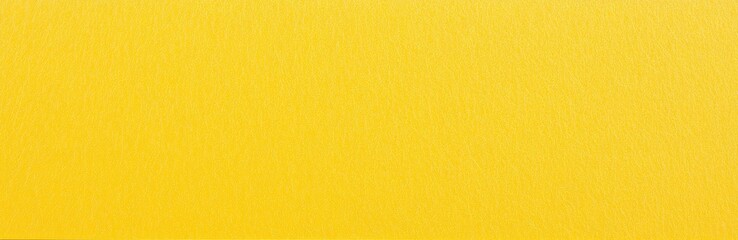 Fototapeta premium Bright yellow plain paper texture with a smooth finish