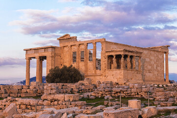 Erechtheion Temple on the Acropolis of Athens at sunset, featuring iconic Caryatids and ancient...