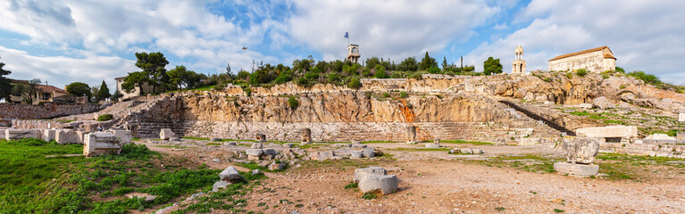 Panoramic view of the ruins of the Eleusinian Sanctuary in Greece, featuring ancient stone...