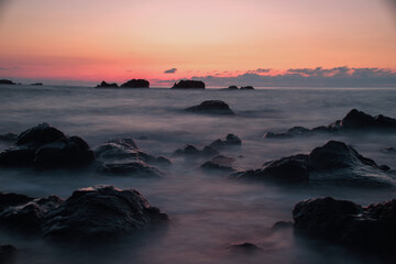 Sea and rocks at sunset . Long exposure